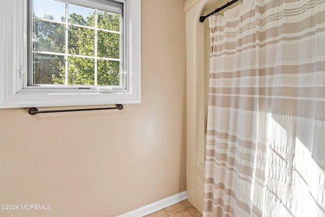 bathroom with tile patterned flooring and walk in shower