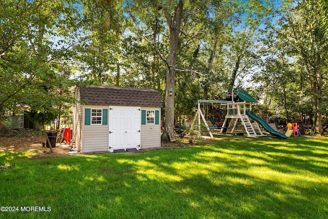 view of yard with a storage shed and a playground