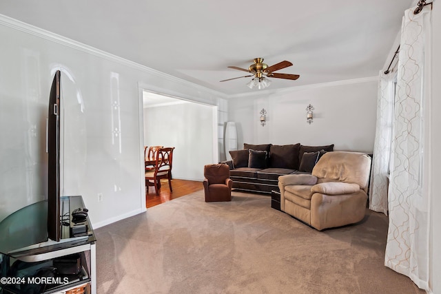 living room featuring ornamental molding, carpet, and ceiling fan