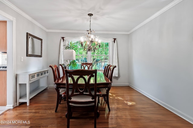 dining space with a notable chandelier, ornamental molding, and dark hardwood / wood-style flooring