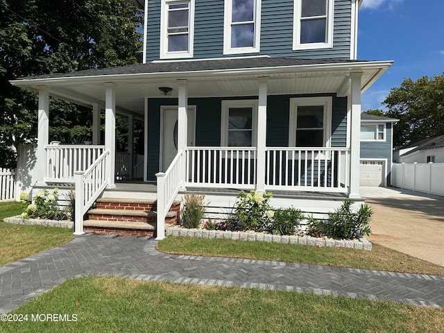 view of front of property with a porch and a garage