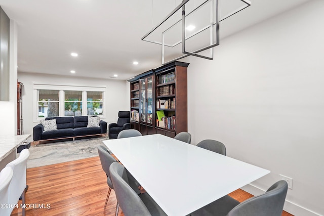 dining space with wood-type flooring