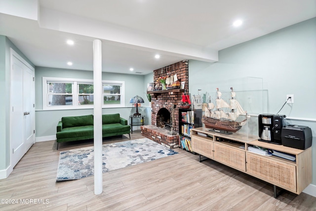 living room with a fireplace and light hardwood / wood-style flooring