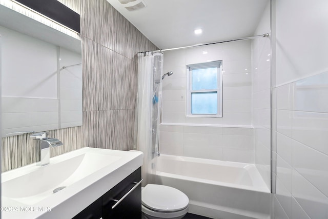 full bathroom with shower / bathtub combination with curtain, toilet, tile walls, and vanity