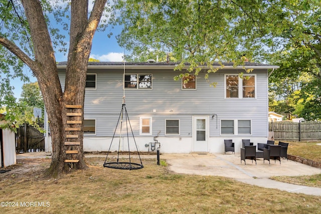 rear view of house with a lawn and a patio area