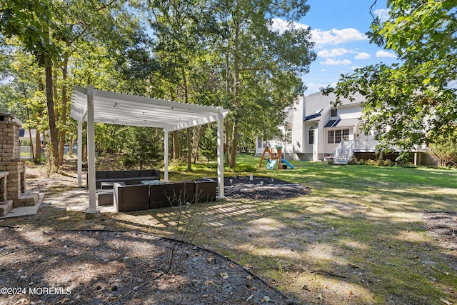 view of yard featuring an outdoor living space, a pergola, and a playground