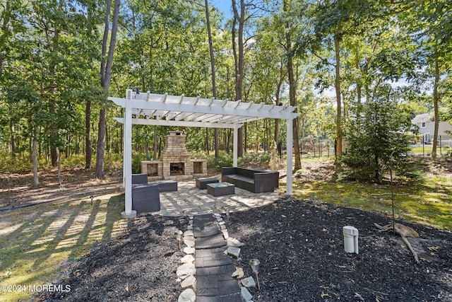 view of yard with an outdoor living space with a fireplace