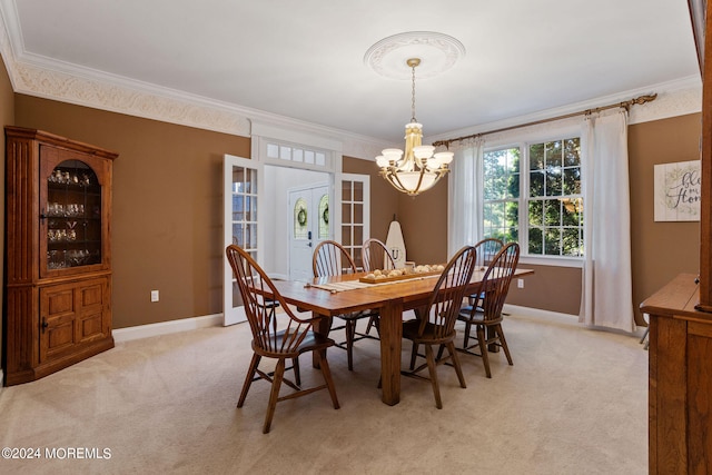 carpeted dining space with french doors, an inviting chandelier, and ornamental molding