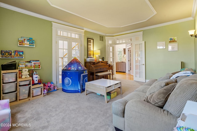 living room featuring carpet, a healthy amount of sunlight, ornamental molding, and french doors