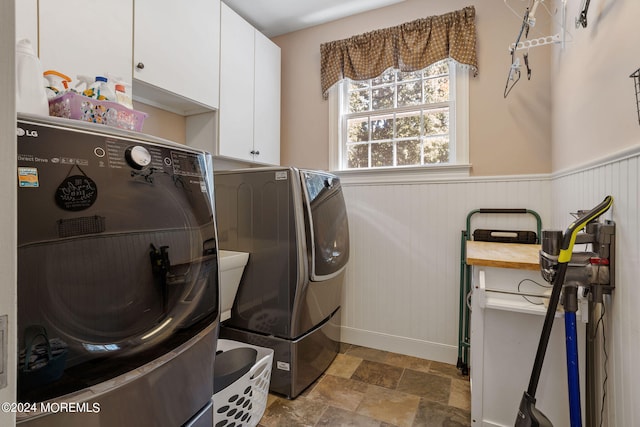 laundry room featuring washing machine and dryer and cabinets