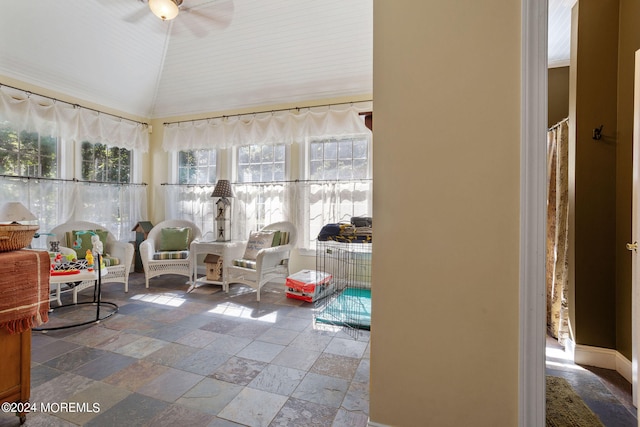 sunroom / solarium with ceiling fan and vaulted ceiling