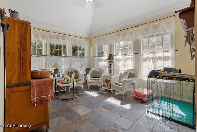 sunroom / solarium with a healthy amount of sunlight and vaulted ceiling