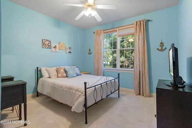 bedroom with ceiling fan and light colored carpet