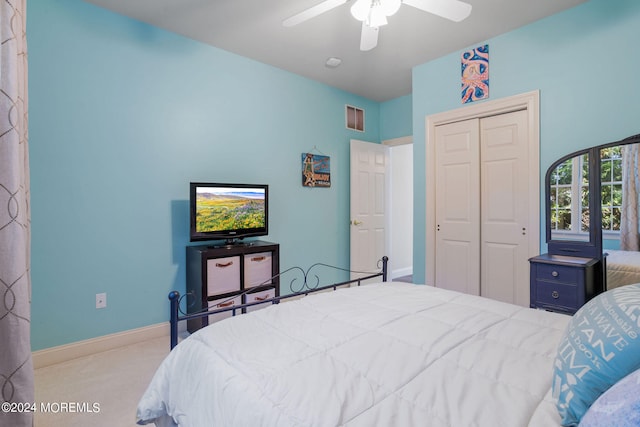 bedroom featuring light carpet, a closet, and ceiling fan