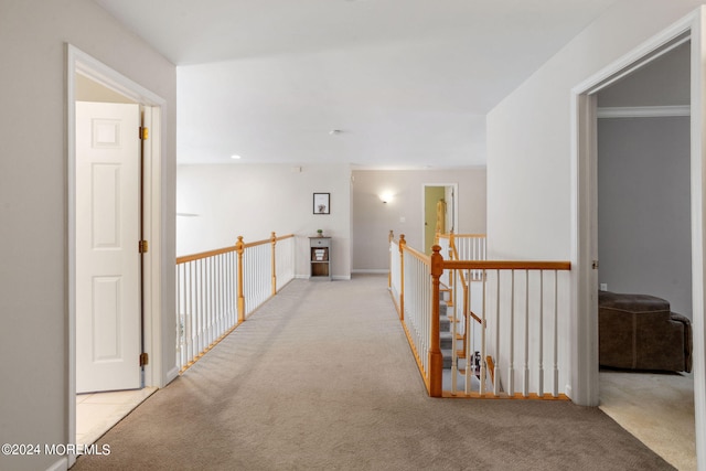 corridor featuring light colored carpet