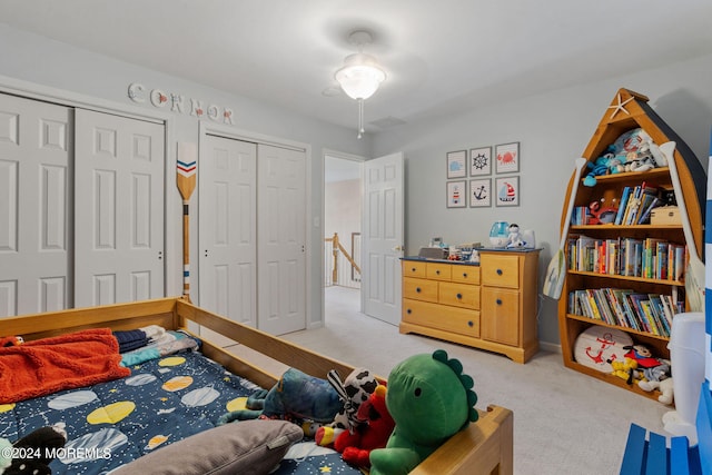 carpeted bedroom featuring multiple closets