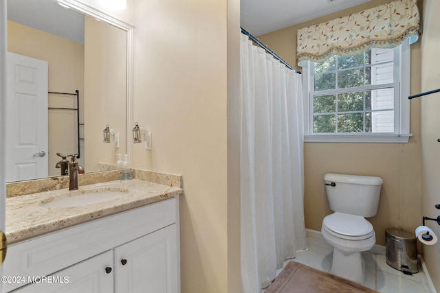 bathroom featuring toilet, vanity, and tile patterned floors