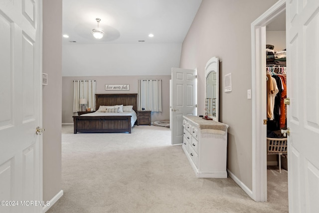 carpeted bedroom featuring a spacious closet and lofted ceiling