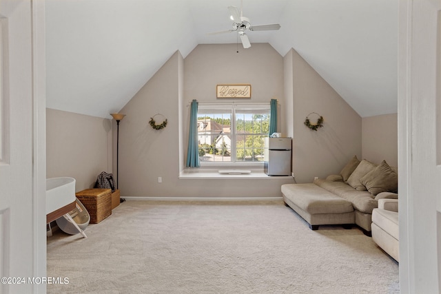 living area featuring ceiling fan, lofted ceiling, and light carpet