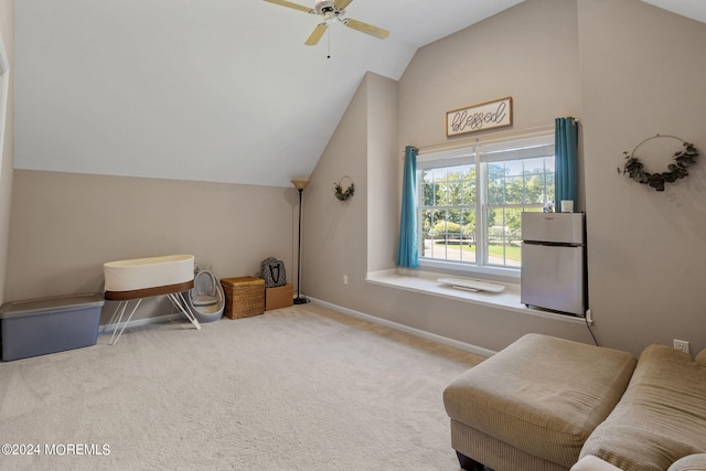 living area featuring ceiling fan, carpet floors, and vaulted ceiling