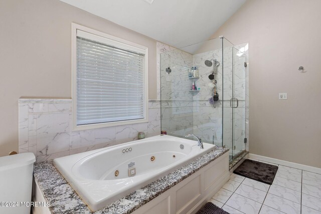 bathroom featuring separate shower and tub