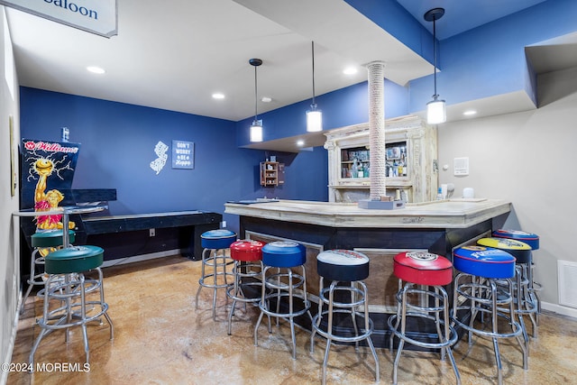 bar featuring hanging light fixtures