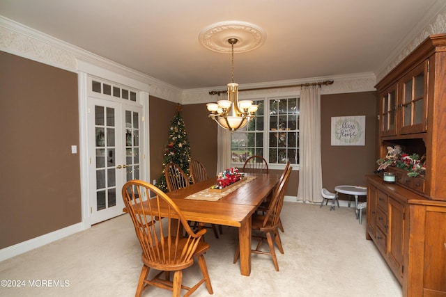 dining space featuring an inviting chandelier, light colored carpet, ornamental molding, and french doors