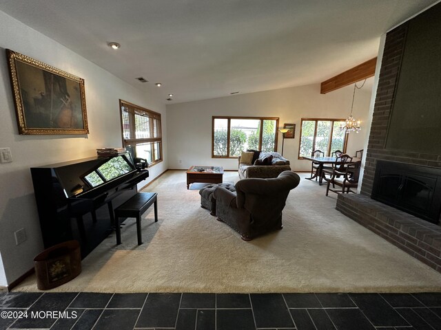 carpeted living room with lofted ceiling with beams, an inviting chandelier, and a fireplace