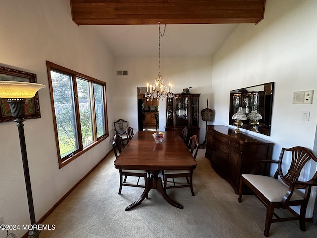 dining area with high vaulted ceiling, beam ceiling, light colored carpet, and a chandelier