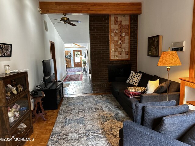 living room with parquet flooring, a brick fireplace, and ceiling fan