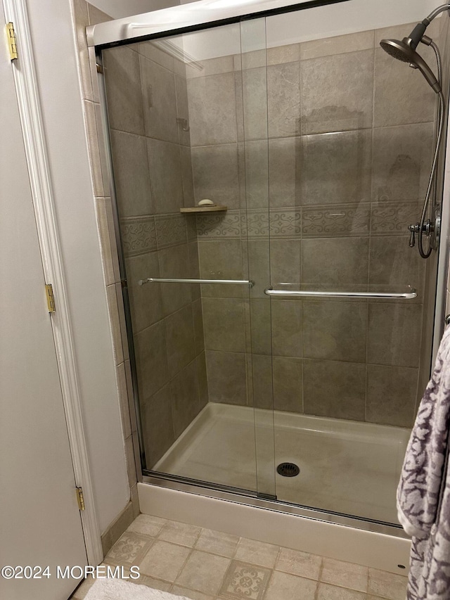 bathroom featuring a shower with door