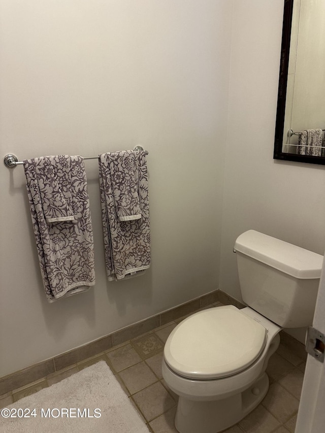 bathroom with tile patterned flooring and toilet