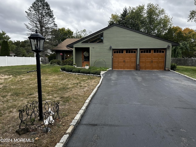 view of front of house with a front yard and a garage