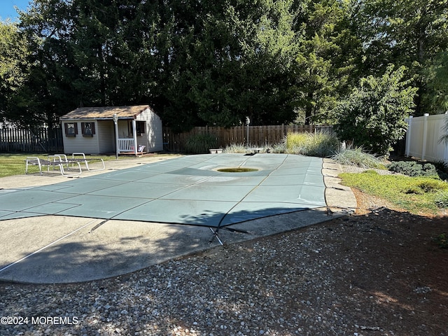 view of pool with an outdoor structure and a patio area