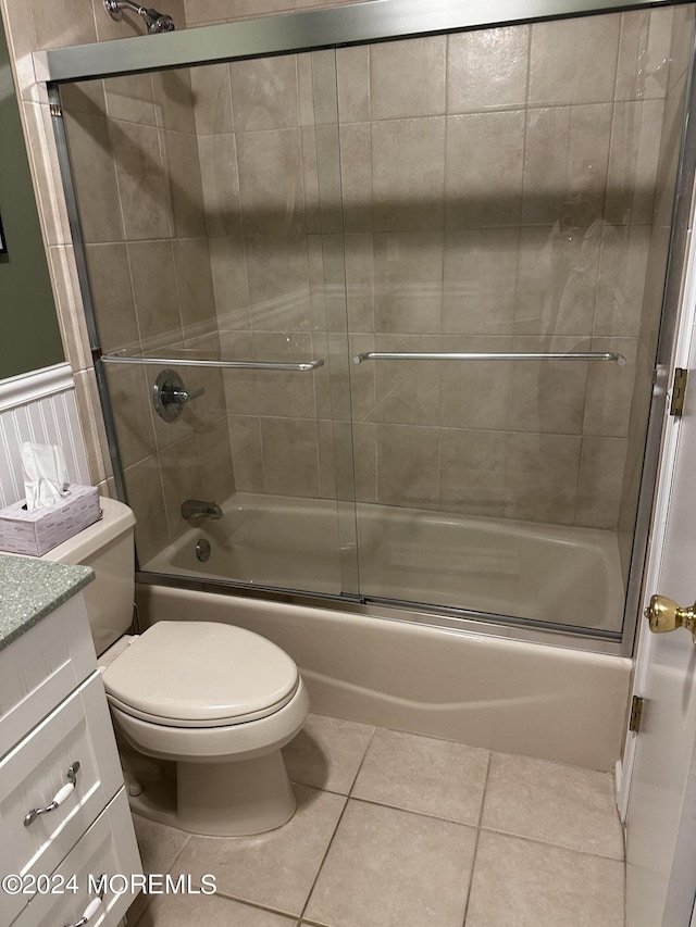 full bathroom with vanity, tile patterned flooring, combined bath / shower with glass door, and toilet