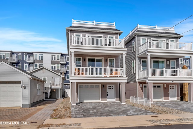 view of front facade featuring a garage and a balcony