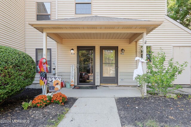 view of exterior entry with a porch