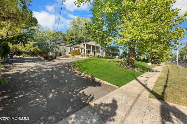 view of front facade with a front yard and a porch