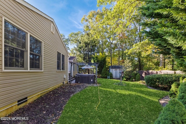 view of yard featuring a storage unit and a hot tub