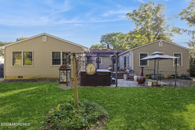 rear view of property featuring a patio, a yard, and a pergola