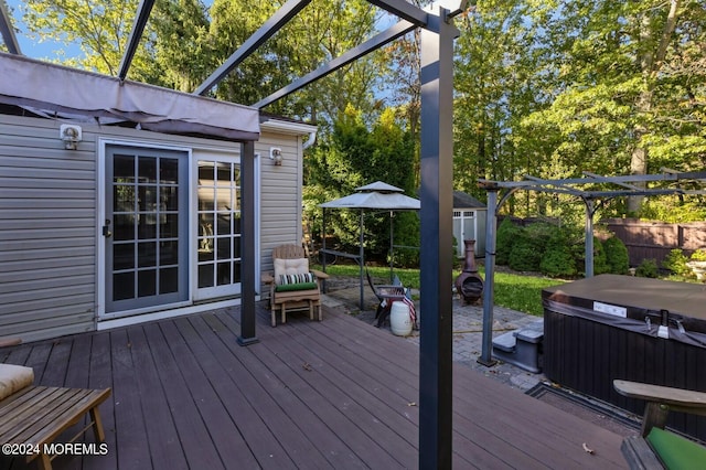 deck featuring a pergola and a hot tub