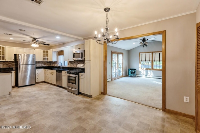 kitchen featuring tasteful backsplash, sink, hanging light fixtures, white cabinetry, and appliances with stainless steel finishes