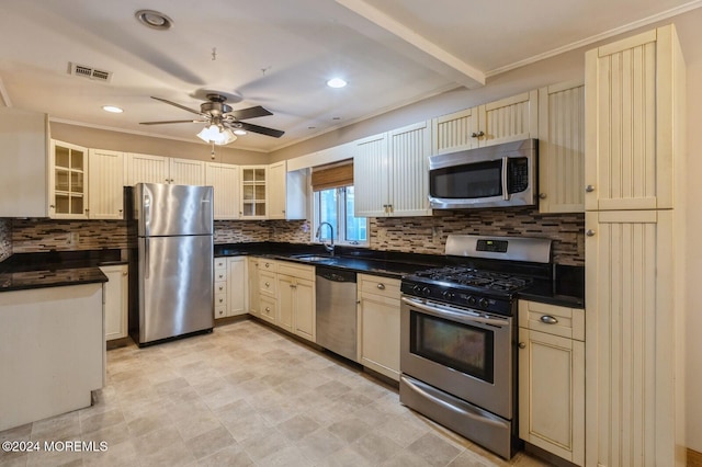 kitchen with ceiling fan, ornamental molding, sink, tasteful backsplash, and stainless steel appliances