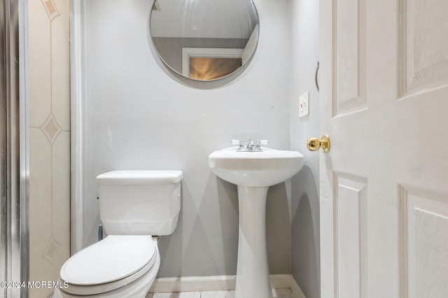 bathroom with tile patterned flooring and toilet