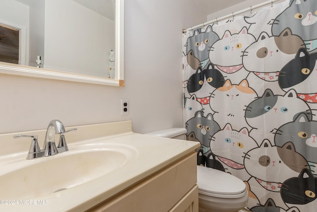 bathroom featuring vanity, toilet, and a shower with shower curtain