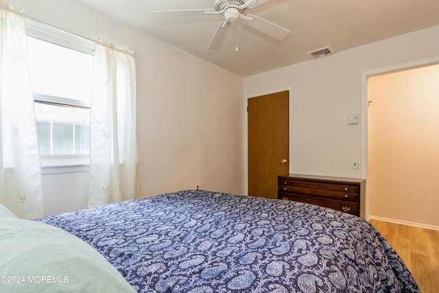 bedroom with wood-type flooring and ceiling fan