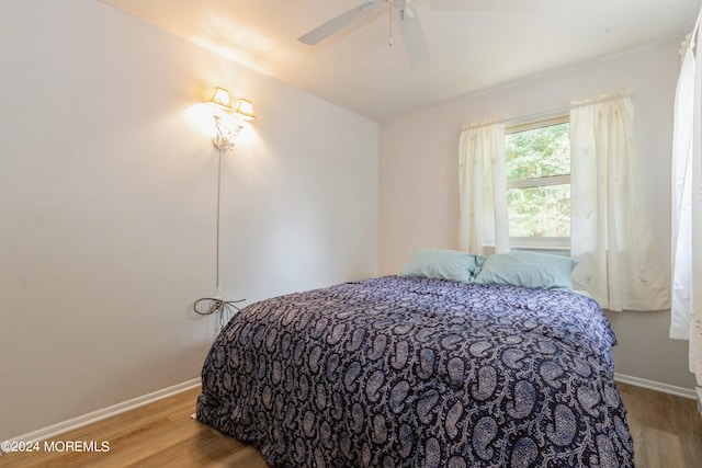 bedroom with ceiling fan and hardwood / wood-style floors