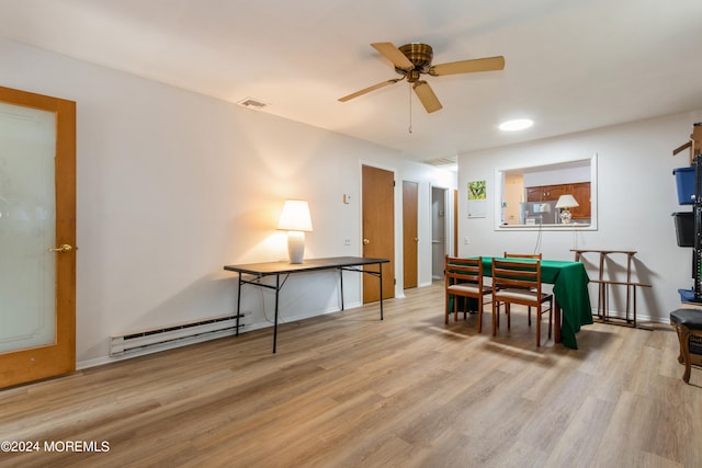 dining room with baseboard heating, light hardwood / wood-style flooring, and ceiling fan