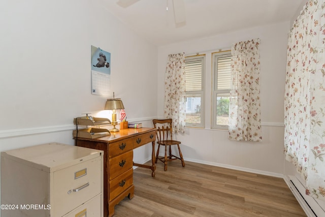 office with baseboard heating, light hardwood / wood-style flooring, and ceiling fan