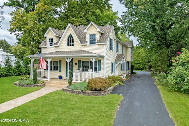 view of front of property with a porch and a front yard